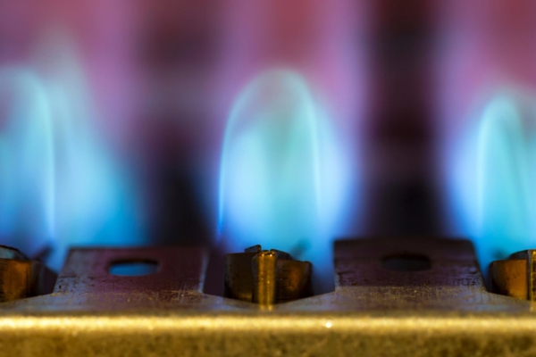 Close up of a water heater pilot fire.