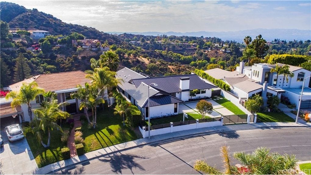 Aerial photo of three luxury homes in the hills of Encino on a sunny day