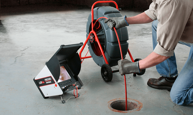 A Ridgid SeeSnake diagnostic camera being used to inspect and locate a blockage inside a sewer line.
